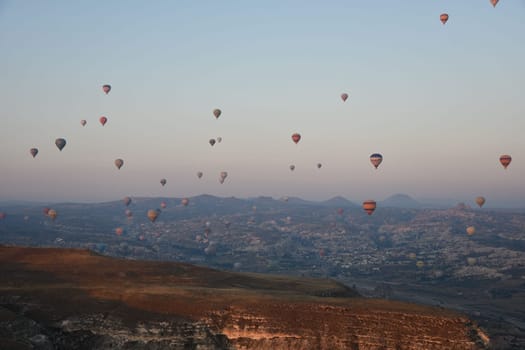 Hot air balloons in the sky over Goreme in Cappadocia, Turkey on a sunsrise