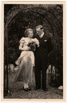 GERMANY - MARCH, 1937: Vintage photo shows young lovers. Antique black& white photography.