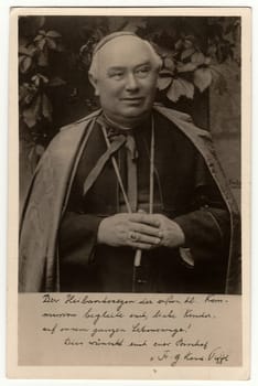 GERMANY - CIRCA 1950s: Vintage photo shows a catholic priest. Black white antique photography.