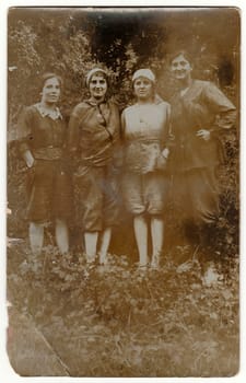 GERMANY - 1917: Vintage photo shows young rural women pose in nature. Black & white antique photography.