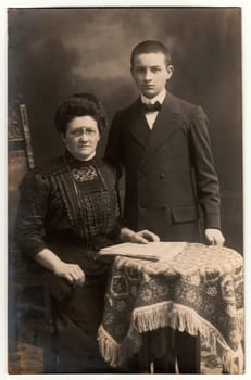 GERMANY - CIRCA 1930s: Vintage photo shows mother and her son. Black white studio photography.