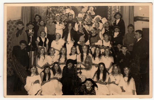 THE CZECHOSLOVAK REPUBLIC - CIRCA 1950s: Vintage photo shows a big group of children with teacher. They wear costums for theatre performance.