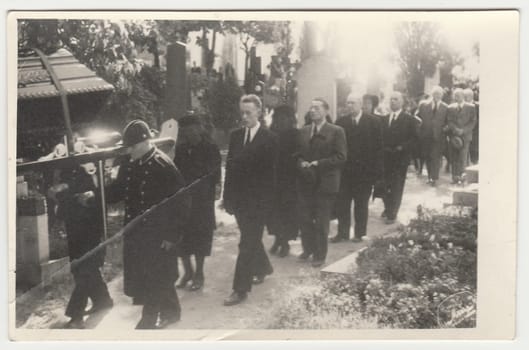 PRAHA (PRAGUE), THE CZECHOSLOVAK REPUBLIC - CIRCA 1940s: Funeral clerks carry the coffin lies on bier. Black & white antique photo.