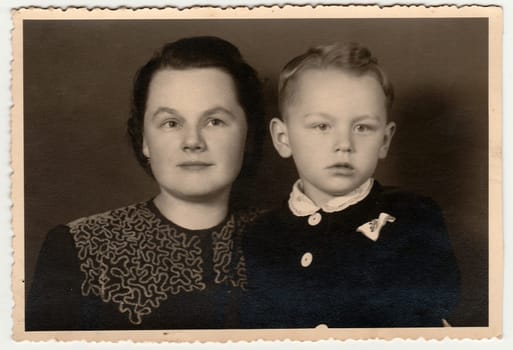 THE CZECHOSLOVAK REPUBLIC - JULY 27, 1934: Vintage photo shows mother with her son. Black & white antique photography.