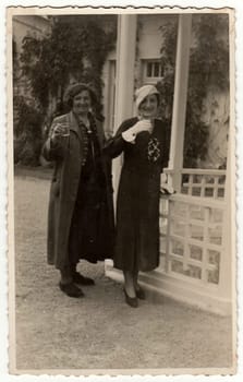 TRENCIANSKE TEPLICE, THE CZECHOSLOVAK REPUBLIC - CIRCA 1930s: Vintage photo shows elegant women at the spa resort. Black & white antique photography.