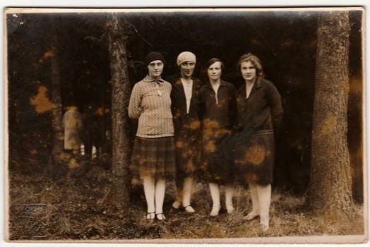 NOVA PAKA, THE CZECHOSLOVAK REPUBLIC - 1929: Vintage photo shows young women pose in nature. Black & white antique photography.