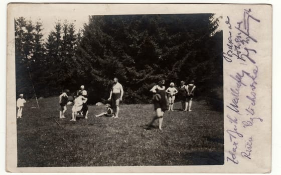 SLIAC, THE CZECHOSLOVAK REPUBLIC - AUGUST 6, 1921: Vintage photo shows people during summer time. People wear period swimsuit and have a rest during vacation.