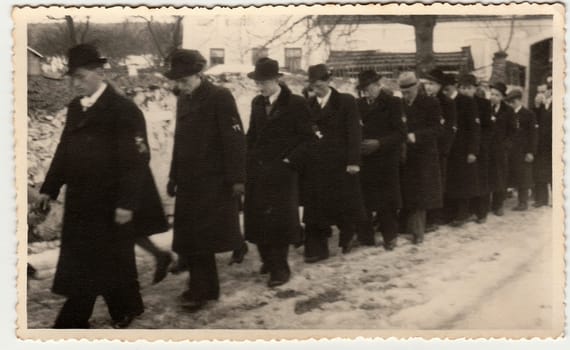 THE CZECHOSLOVAK REPUBLIC - CIRCA 1930s: Vintage photo shows crowd of men during winter time. Black & white antique photography.