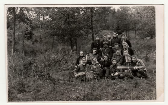 THE CZECHOSLOVAK REPUBLIC - CIRCA 1950s: Vintage photo shows rural women and gamekeeper in the forrest . Black & white antique photography.