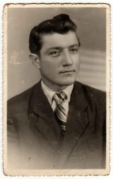 HRADEC KRALOVE, THE CZECHOSLOVAK SOCIALIST REPUBLIC - CIRCA 1950s: The vintage photo shows young man. The studio photography was taken for A level (GCSE exam) occasion.