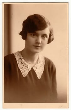 PRAHA PRAGUE , THE CZECHOSLOVAK REPUBLIC - CIRCA 1930s: The vintage photo shows portrait of young woman. The studio photography with sepia effect was taken in early 1930s.