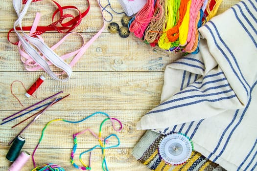 Threads and accessories for sewing and knitting. Selective focus. white.