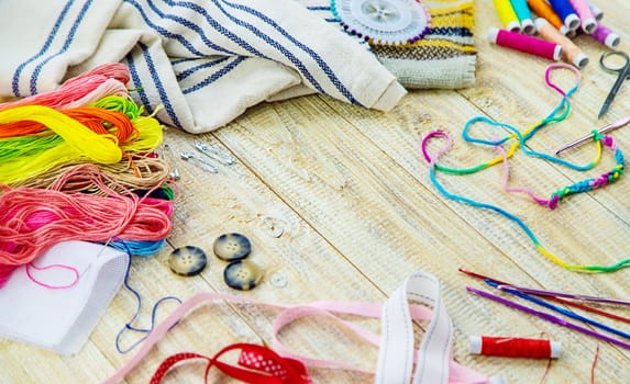 Threads and accessories for sewing and knitting. Selective focus. white.