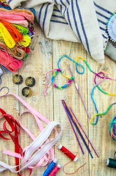 Threads and accessories for sewing and knitting. Selective focus. white.