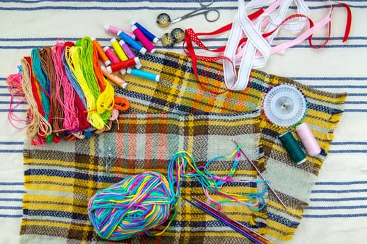 Threads and accessories for sewing and knitting. Selective focus. white.