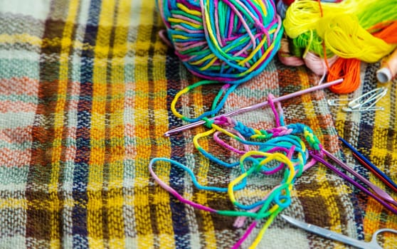 Threads and accessories for sewing and knitting. Selective focus. white.