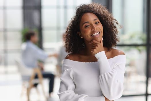 Portrait of an African American young business woman working in the office.