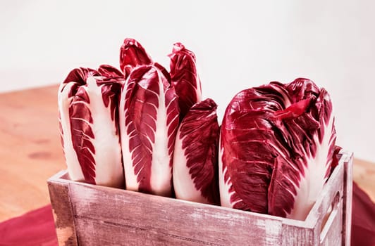 Radicchio, red  leaves chicory, italian chicory in wooden crate , common use in Italian cuisine