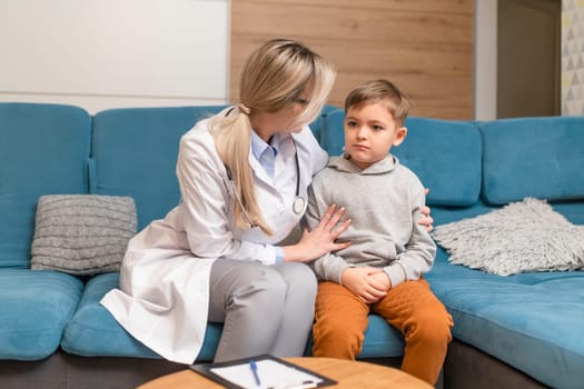 A family doctor examines a little boy at home. Pediatrician girl treats a child.