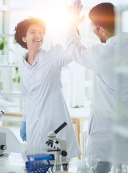 Team of Scientists Working Using Microscope, Analysing Microbiology Samples