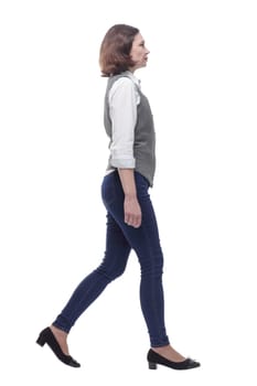 side view. Mature woman in casual clothes walking forward. isolated on a white background.