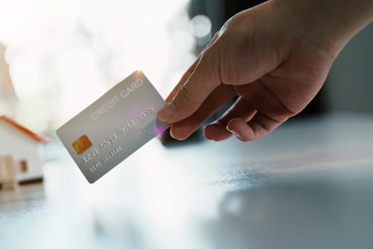 Portrait of young Asian woman holding credit card for online shopping.