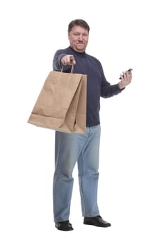 in full growth. casual man with a smartphone .isolated on a white background.