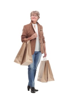 Full length portrait of a Senior woman walking with shopping bags and smilimg