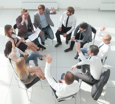 top view. a team of young employees sitting in a circle in the conference room .
