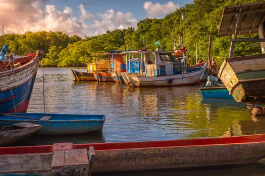 Idyllic Porto Seguro Beach at sunset with fishermen rustic wooden boats, BAHIA, Brazil