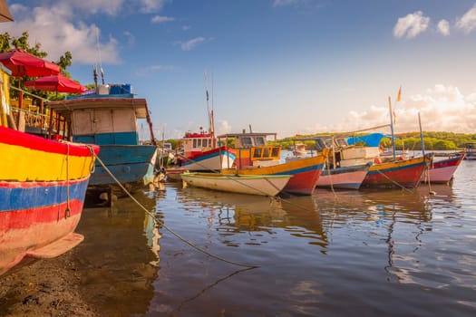 Idyllic Porto Seguro Beach at sunset with fishermen rustic wooden boats, BAHIA, Brazil