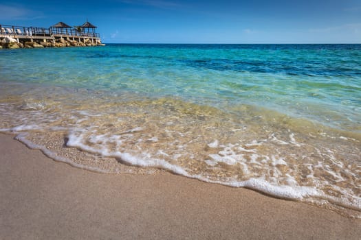 Tropical caribbean beach with turquoise waters in idyllic Montego Bay, Jamaica