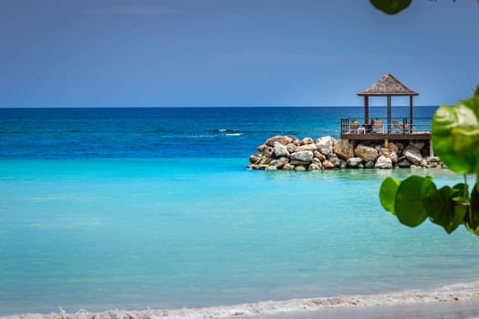 Tropical caribbean beach with turquoise waters in idyllic Montego Bay, Jamaica