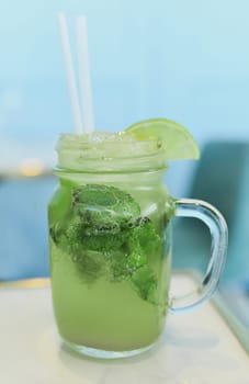 Mojito with lime and mint in a glass mug