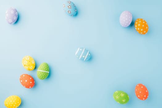 Colorful easter eggs isolated on blue background with copy space, Funny decoration, Creative composition banner web design holiday background, Happy Easter Day greeting card, flat lay top view