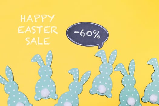 holiday promo composition Easter sale bunnies and text message on bold yellow paper background. copy space. Template Easter day