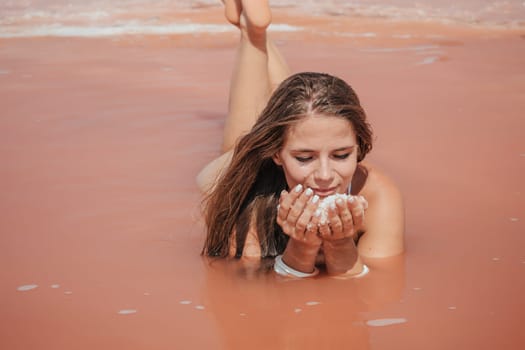Salt mining. Salty pink lake with crystals of salt. Extremely salty pink lake, colored by microalgae with crystalline salt depositions