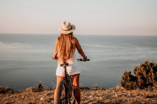 Woman travel sea. Young Happy woman in a long red dress posing on a beach near the sea on background of volcanic rocks, like in Iceland, sharing travel adventure journey