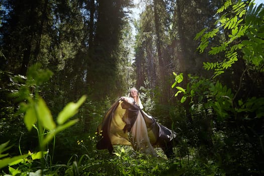 Beautiful seductive dryad. Pagan spirit of forest. Portrait of beautiful dryad. Fairy who loves nature in beautiful green summer forest. Concept of environmental friendliness and caring for nature