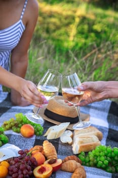 couple in love drinking white wine on a picnic. Selective focus. nature