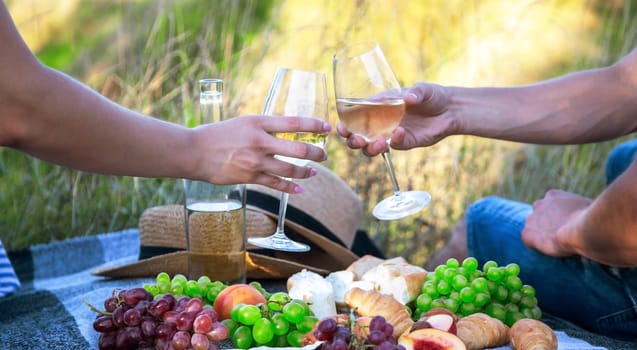 couple in love drinking white wine on a picnic. Selective focus. nature