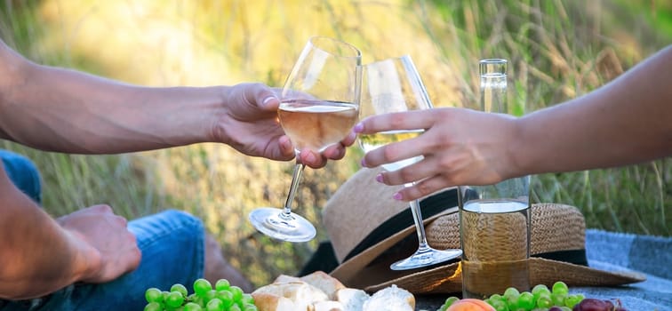 couple in love drinking white wine on a picnic. Selective focus. nature