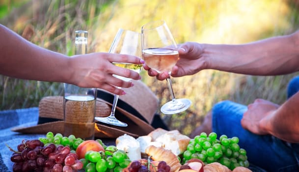 couple in love drinking white wine on a picnic. Selective focus. nature