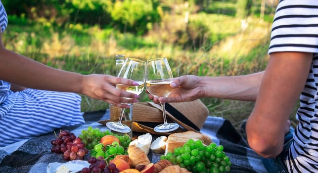 couple in love drinking white wine on a picnic. Selective focus. nature