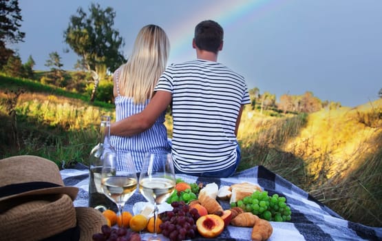 couple in love drinking wine on a picnic. Nature. Selective focus
