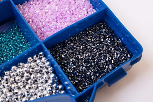 Colorful beads in containers close up, handicrafts, macrophoto