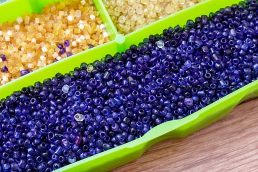 Colorful beads in containers close up, handicrafts, macrophoto