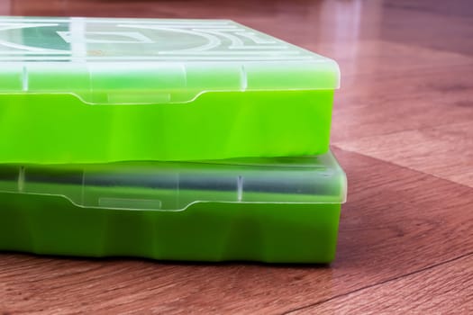 Small storage containers on a wooden floor close up