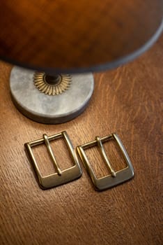 Set of decorative buckles made of metal on a wooden table