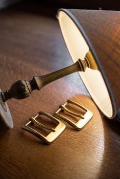 Set of decorative buckles made of metal on a wooden table